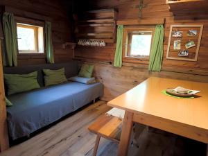 a living room with a couch and a table at Almhuette Auszeit in Donnersbachwald