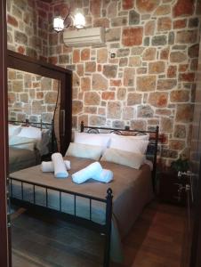 a bedroom with a bed in a brick wall at Villa Despoina in Amarinthos