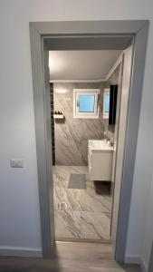 a bathroom with a toilet and a sink and a mirror at Lapus Residence Apartament in Craiova +33 photos