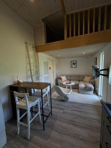 a living room with a table and a couch at Villa Söderläget in Laholm