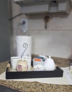 a tray with cups and cups on a counter at Departamento Villa 5 in Villa Carlos Paz