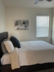 a bedroom with a bed with pillows and a window at Hi-Tech Haven by Hospital & Lake in Granbury