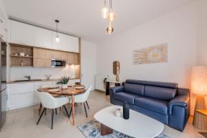 a living room with a couch and a table at Charming Lodge Disneyland Paris - 4 pers - 1 Ch - 15 min in Chessy