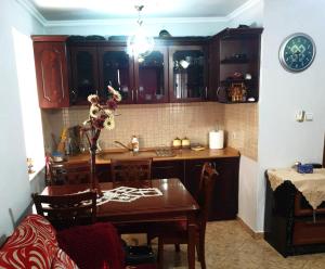 a kitchen with a table and a dining room at ALTURA Apartment in Ersekë