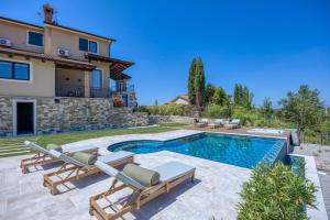 a villa with a swimming pool and a house at Villa Clara Meloni in Motovun