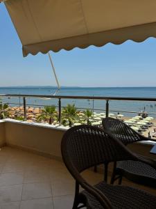 a balcony with chairs and a view of the beach at Odi Apartments in Durrës +74 photos