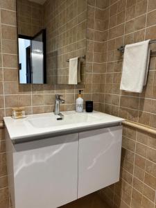 a bathroom with a white sink and a mirror at Odi Apartments in Durrës +74 photos