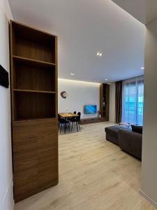 a living room with a couch and a table at Odi Apartments in Durrës