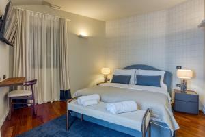 a bedroom with a large bed with two pillows on it at Villa Clara Meloni in Motovun +42 photos