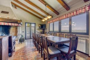a dining room with a table and chairs and a fireplace at Villa Clara Meloni in Motovun