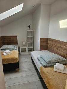 Łóżko lub łóżka w pokoju w obiekcie Polna Sarbinowo