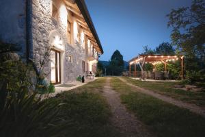 a building with lights on the side of it at TheGreenShelter in Čepovan