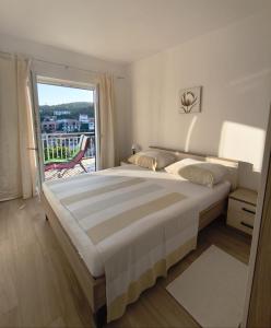 Postel nebo postele na pokoji v ubytování Apartments Laus
