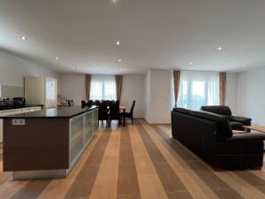 a kitchen and living room with a table and chairs at Villa Santolina in Maslenica