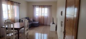 a living room with a table and a couch at Sams House in Espargos