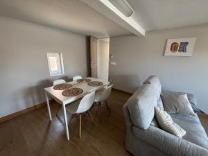 a living room with a table and a couch at Instant paisible in Rountzenheim