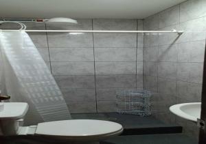 a bathroom with a shower with a toilet and a sink at El Barco Colonial in Quito +9 photos