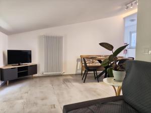 a living room with a couch and a tv and a table at B&B Il sentiero del bosco in Buia