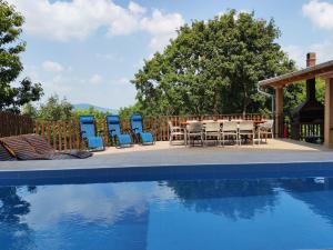 a table and chairs next to a swimming pool at LipaHill Luxe in Ripanj