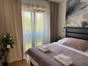a bedroom with a bed with two towels on it at HORIZON Privlaka3 in Privlaka
