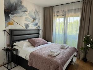 a bedroom with a bed with two towels on it at HORIZON Privlaka3 in Privlaka