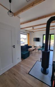 a living room with a black stove in a room at W Małym Sadzie in Dobra