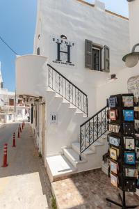 a white building with stairs on the side of it at Etemis Home Naxos Down Town in Naxos Chora
