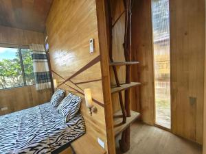 a small room with a bed and a wooden wall at Retazos Eco Hotel in Iquitos +12 photos