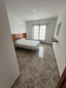 a living room with a couch and a window at La Casa Rosada 2 in Arrecife