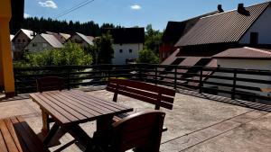 a wooden bench sitting on top of a balcony at Balkan Vibe Apartments in Žabljak