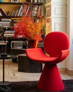 a red chair in a room with a piano at Beausejour Ranelagh in Paris +80 photos