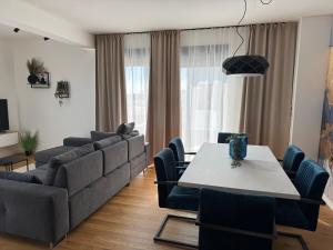 a living room with a couch and a table and chairs at HORIZON Privlaka3 in Privlaka