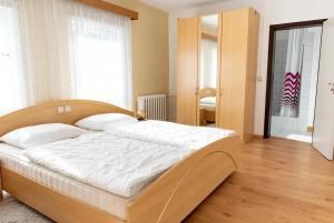 a bedroom with a large bed in a room at Hotel Appartementanlage Hermannshöhle in Elbingerode
