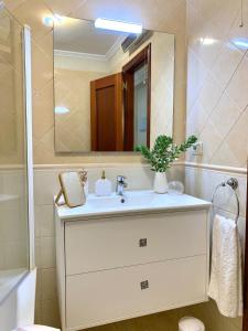 a bathroom with a sink and a mirror at Betalia II in Caldas de Reis +22 photos