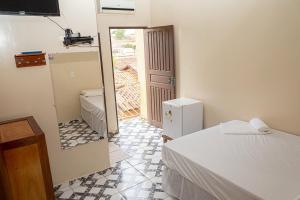 a room with a room with a bed and a door at Junior Hotel in Anapu