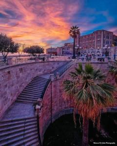 a bridge over a river with a palm tree at Blue Orchid Apartment, IUN S8460 in Quartu SantʼElena +55 photos