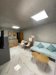 a bedroom with a bed and a table with chairs at The Secret Studio - OAKA Stadium & nearby hospitals in Athens