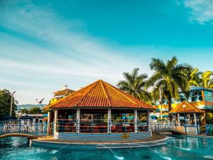 a resort with a swimming pool and a building at HCR Hotel y Centro de Convenciones Chinauta Real in Fusagasuga
