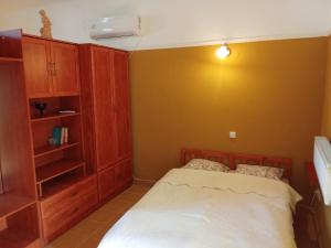 a bedroom with a bed and a book shelf at 20 Bakancs Apartman in Esztergom