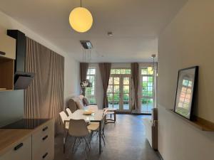 a kitchen and living room with a table and chairs at yusuite 2 in Hamburg