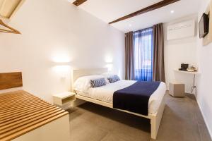 Postel nebo postele na pokoji v ubytování Oblò Portovenere Guesthouse