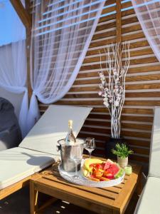 a table with a plate of fruit and a glass of wine at Vila Gracija in Arandelovac
