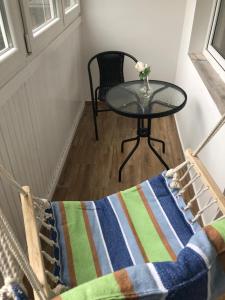 a table and a chair and a table with a vase at Apartament JANA PAWŁA in Włodawa +21 photos