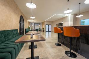 a lobby with green furniture and orange chairs at The GuestHouse Company Limited in Lagos