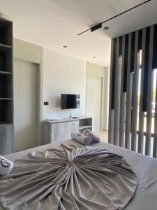 a bedroom with a large bed with two pillows on it at Hotel Bristol Velipoje in Velipojë