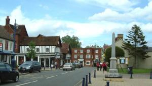 a small town with cars parked on a street at The White Hart Hotel in Shefford