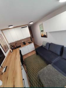 a living room with a couch and a table at Mikrokawalerka w ścisłym centrum in Legnica