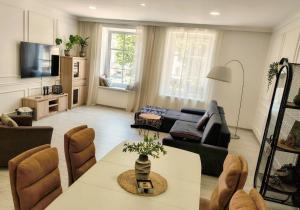 a living room with a couch and a table at Apartament Na Starówce in Kłodzko