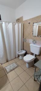 a bathroom with a toilet and a sink at Las Magnolias in San Miguel