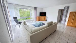 a living room with a couch and a table at 130 qm Apartment mit Garten und Stellplatz in Riegelsberg +30 photos